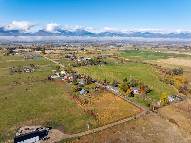 birds eye view of property featuring a mountain view and a rural view