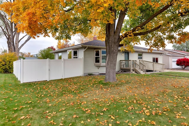 exterior space featuring a lawn and a deck