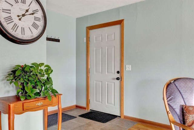 foyer entrance with light tile patterned flooring