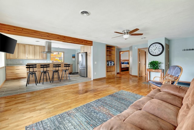 living room with ceiling fan and light wood-type flooring