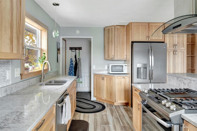 kitchen featuring sink, ventilation hood, pendant lighting, light brown cabinetry, and appliances with stainless steel finishes