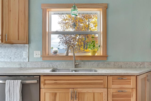 kitchen with dishwasher, sink, pendant lighting, decorative backsplash, and light brown cabinetry