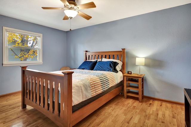 bedroom with ceiling fan and light hardwood / wood-style flooring