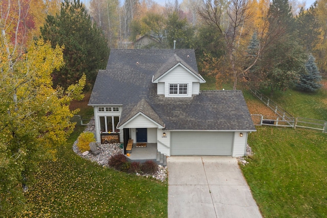 view of front of house with a garage and a front lawn