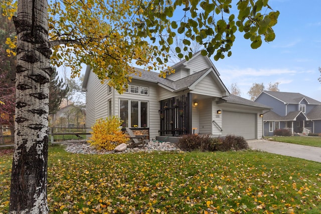 front of property featuring a front yard and a garage