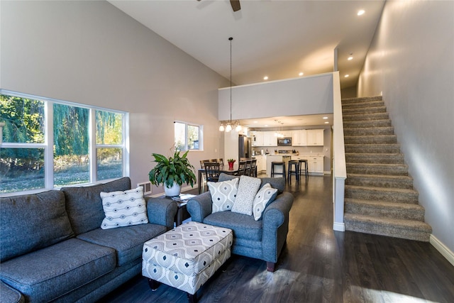 154 Riverside Dr, Kalispell, MT 59901 - living room with high vaulted ceiling, dark wood-style floors, a chandelier, ceiling fan, and stairs
