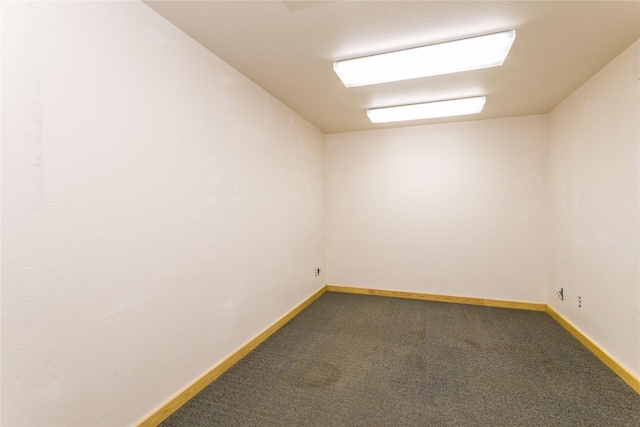 154 Riverside Dr, Kalispell, MT 59901 - spare room featuring dark colored carpet and baseboards