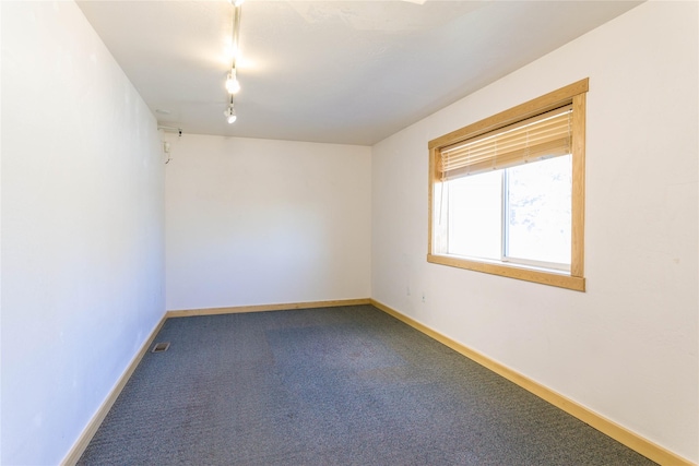 154 Riverside Dr, Kalispell, MT 59901 - empty room featuring carpet flooring, baseboards, and track lighting