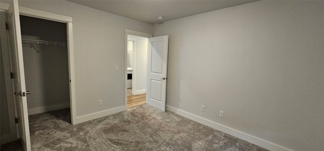 unfurnished bedroom featuring carpet and a closet