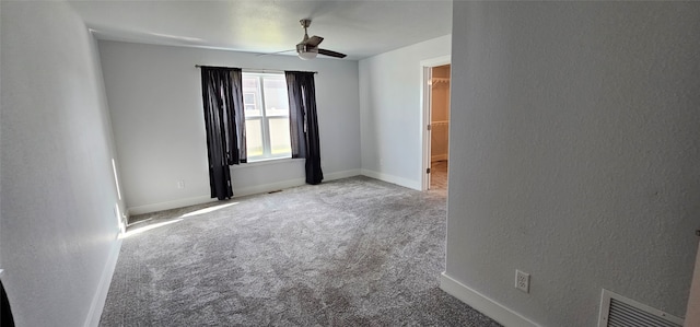 carpeted spare room featuring ceiling fan