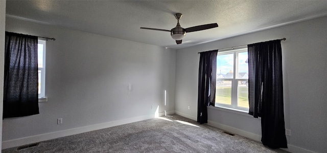 unfurnished room featuring a textured ceiling, carpet floors, and ceiling fan