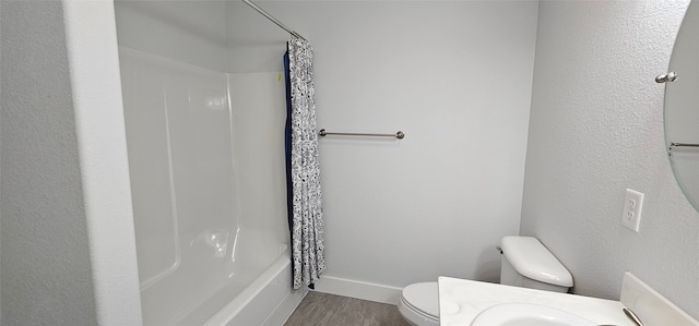 full bathroom with toilet, hardwood / wood-style flooring, vanity, and shower / tub combo