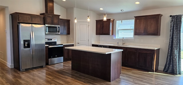 kitchen with hanging light fixtures, a wealth of natural light, sink, vaulted ceiling, and appliances with stainless steel finishes