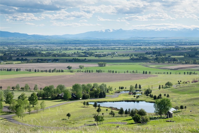 birds eye view of property featuring a water and mountain view and a rural view