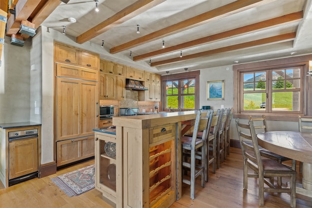 kitchen with backsplash, beamed ceiling, light hardwood / wood-style floors, and a healthy amount of sunlight