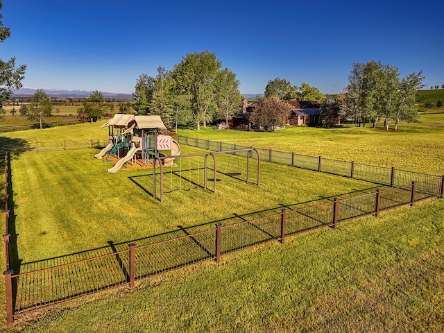 view of yard with a playground and a rural view