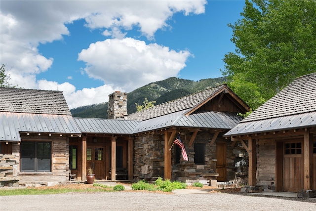 view of front of property with covered porch and a mountain view