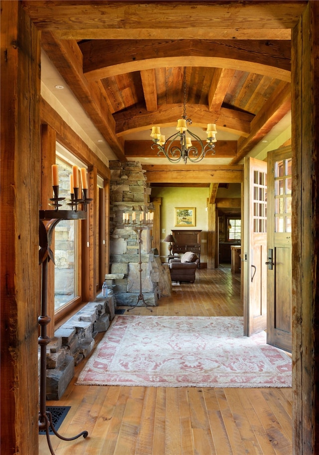 interior space with wood ceiling, wood-type flooring, and a chandelier