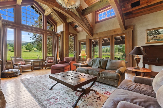 sunroom featuring vaulted ceiling with beams