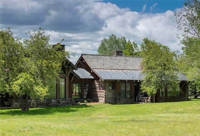 back of property featuring a yard