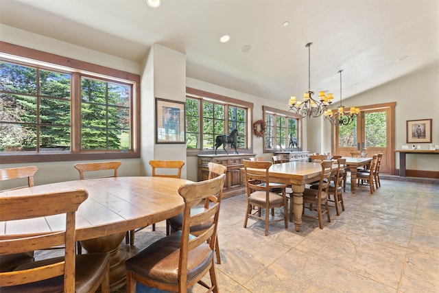 dining room featuring a healthy amount of sunlight, lofted ceiling, and a chandelier