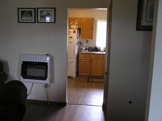 kitchen featuring white fridge and heating unit