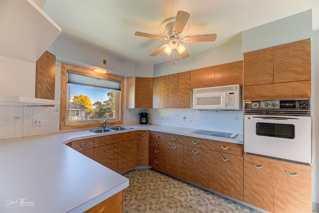 kitchen featuring backsplash, sink, light hardwood / wood-style flooring, and dishwasher