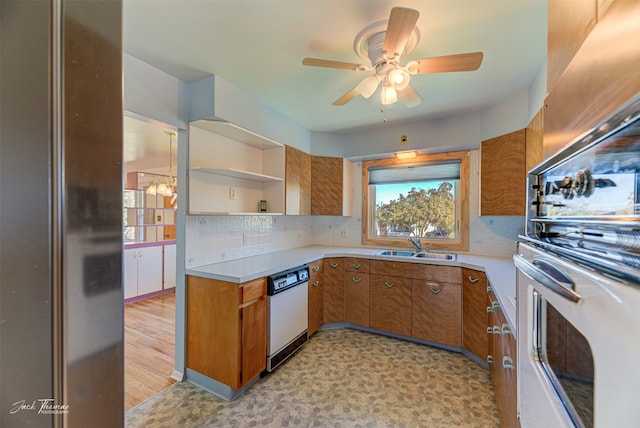 kitchen with backsplash, white appliances, sink, and ceiling fan