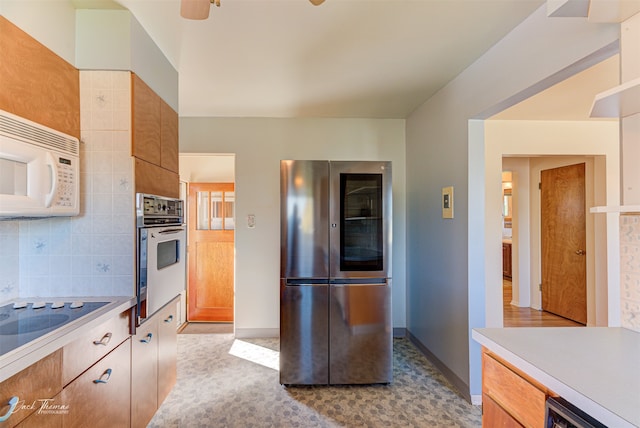 spare room featuring a baseboard heating unit, hardwood / wood-style floors, and ceiling fan