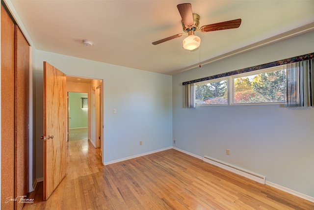 unfurnished room featuring ceiling fan and a baseboard radiator