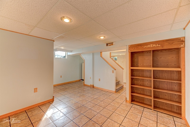 basement with a drop ceiling and carpet floors