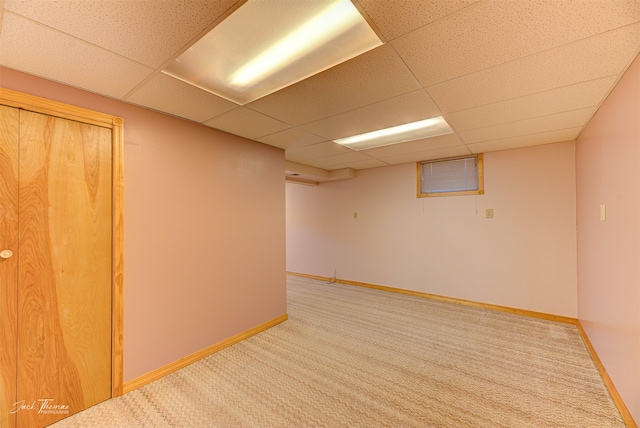 misc room featuring carpet flooring and a paneled ceiling