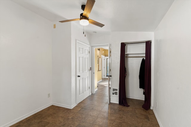 unfurnished bedroom featuring a closet, vaulted ceiling, and ceiling fan