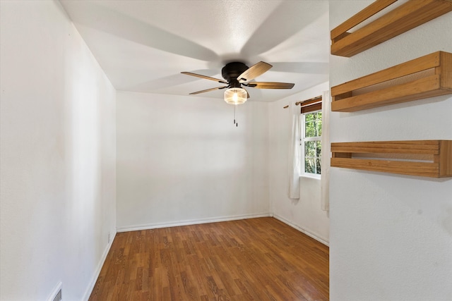 spare room featuring ceiling fan and hardwood / wood-style floors