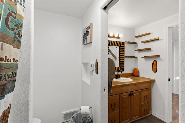 bathroom featuring vanity, toilet, and wood-type flooring