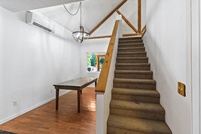 stairs with a notable chandelier, hardwood / wood-style floors, an AC wall unit, and lofted ceiling