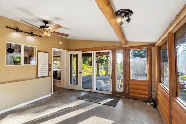 doorway to outside with vaulted ceiling with beams, dark tile patterned flooring, and ceiling fan