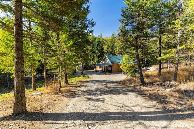1424 Bierney Creek Rd, Lakeside, MT 59922 - rustic home featuring driveway, metal roof, and a forest view