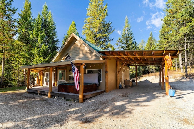 1424 Bierney Creek Rd, Lakeside, MT 59922 - view of front of house featuring a hot tub and a carport