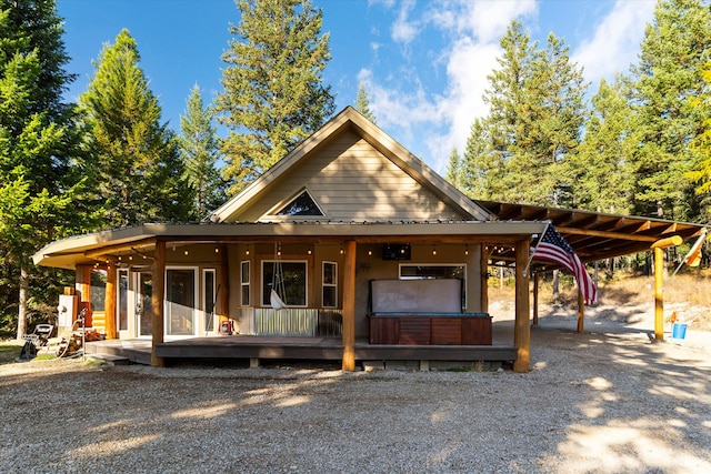 view of front of property with covered porch and a carport