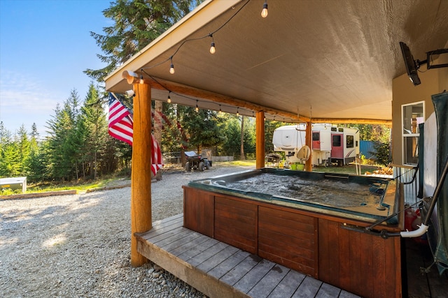 view of patio / terrace with a hot tub