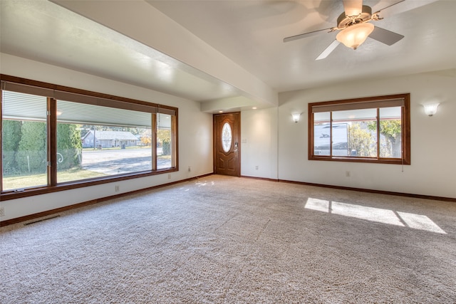 unfurnished living room with carpet and ceiling fan