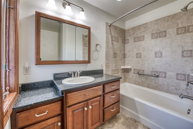 bathroom with tiled shower / bath, vanity, and tile patterned flooring