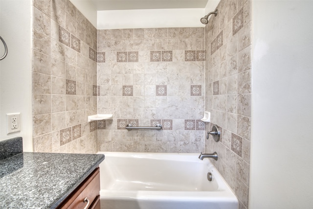 bathroom with vanity and tiled shower / bath combo