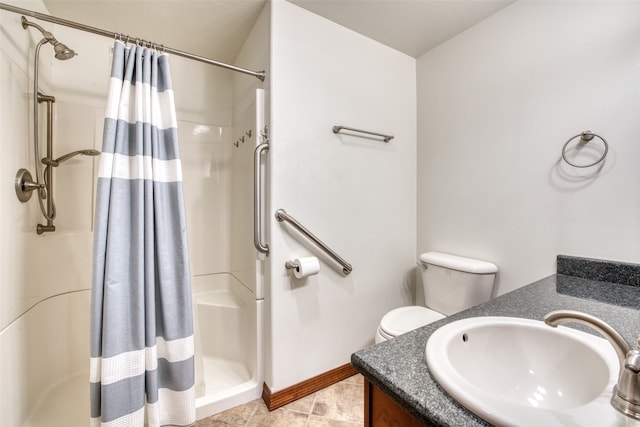 bathroom with curtained shower, vanity, tile patterned floors, and toilet