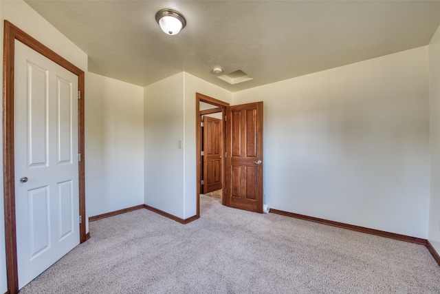 unfurnished bedroom featuring light colored carpet