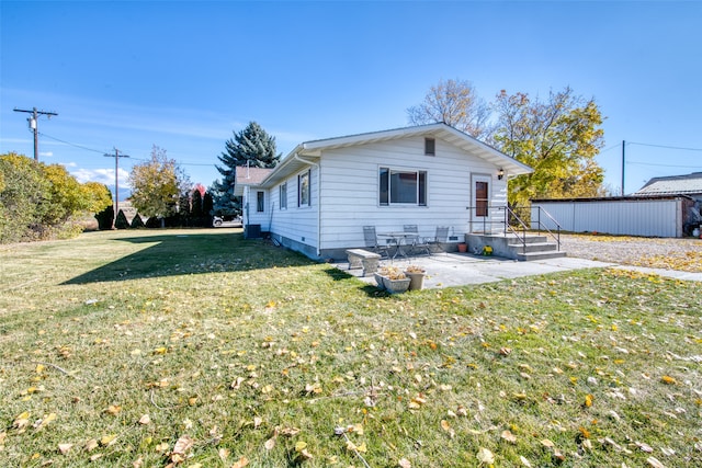 view of front of house with a front yard and a patio