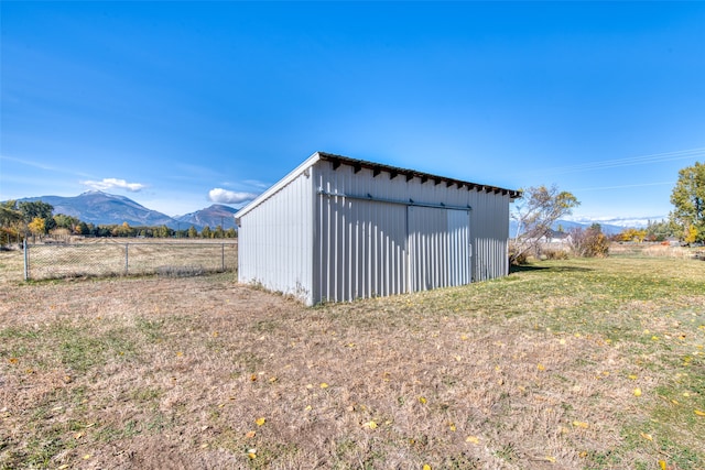 view of outdoor structure featuring a mountain view and a rural view