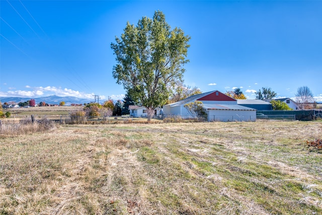 view of yard featuring a rural view and a mountain view