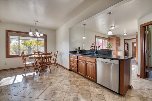 kitchen with hanging light fixtures, a wealth of natural light, and dishwasher